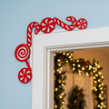 Laser cut wood candy cane corner decoration mounted on top of white interior door frame in cozy Christmas home